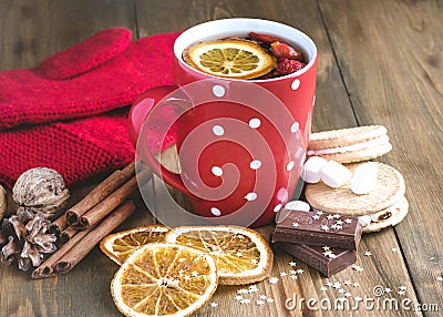 Red cup of hot tea with orange and berries Christmas winter beverage Christmas food concept Wooden background Cinnamone sticks Coo Stock Photo