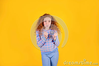 Red curly girl on a yellow background, happy Stock Photo