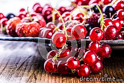 Red currant sponge cake. Plate with Assorted summer berries, raspberries, strawberries, cherries, currants, gooseberries. Stock Photo