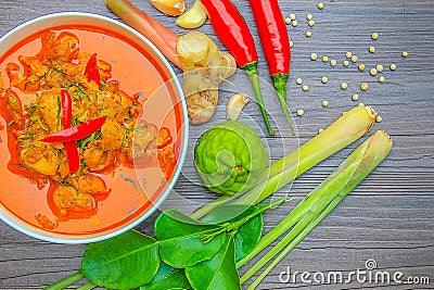 Red curry chicken, Thai Spicy food and fresh herb ingredients on wooden top view / still life, selective focus Stock Photo