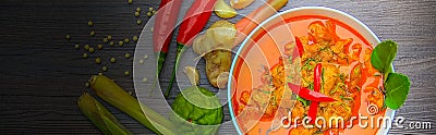 Red curry chicken, Thai Spicy food and fresh herb ingredients on wooden top view / still life, selective focus Stock Photo