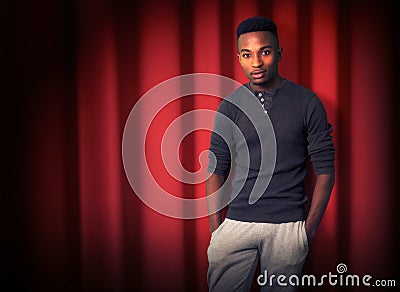 Red curtain stand up comedy scene spotlight show entertainment live stand-up young man Stock Photo