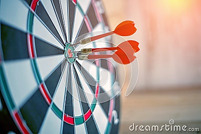 Red dart arrow hitting in the target center Stock Photo