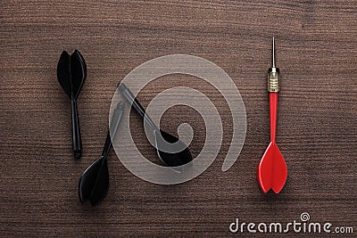 Red dart uniqueness concept on wooden background Stock Photo