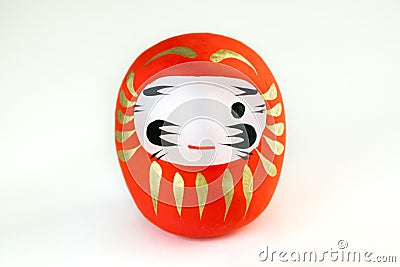 Red Daruma with one eye painted on white background Stock Photo