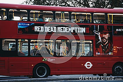 Red Dead Redemption 2 game advertisement on a red double decker Editorial Stock Photo