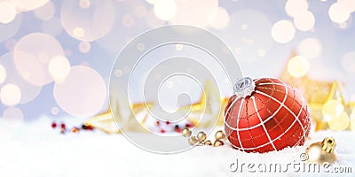 Red decorative ball on the christmas tree on glitter bokeh background with golden twinkle lights Stock Photo