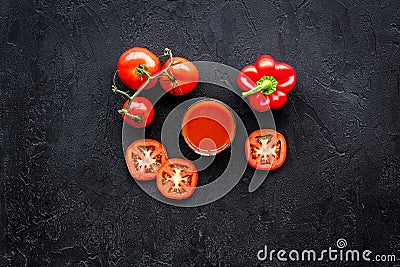 Red detox beverage with paprika and tomatoes on black background top view Stock Photo