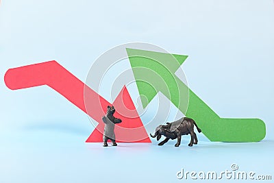 Red downward arrow and green upward arrow beside a bear and bull animal figure. Bearish versus Bullish market clash in stocks and Stock Photo