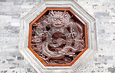 Red dragon carving on wall Stock Photo