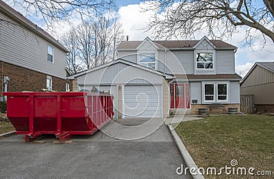 Red Dumpster Bin on the Driveway of a Suburban House #1 Stock Photo