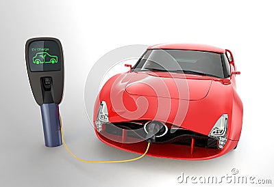 Red electric sports car charging at EV charging station Stock Photo