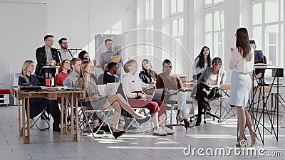 RED EPIC Young female business coach leading seminar event discussion at modern trendy multiethnic office slow motion. Stock Photo