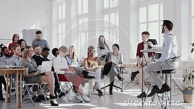 RED EPIC Young male professional business coach speaking at modern office seminar event to multiethnic team slow motion. Stock Photo