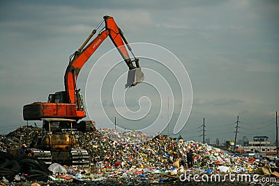 Red excavator in dumpsite Editorial Stock Photo