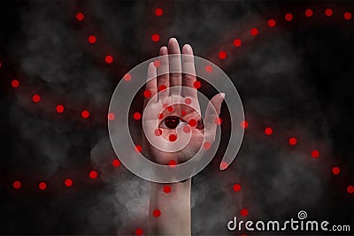 Red eye on hand occultism background concept Stock Photo