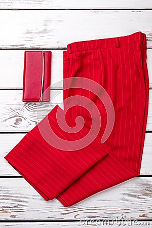 Red fancy women trousers and wallet. Stock Photo