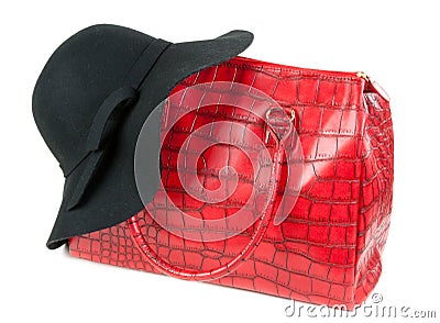 Red Fashion ladies handbag and a black felt hat Stock Photo