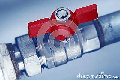 Red faucet on metal water pipe Stock Photo