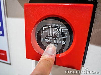 A red fire alarm MCP or manual call point button. Stock Photo