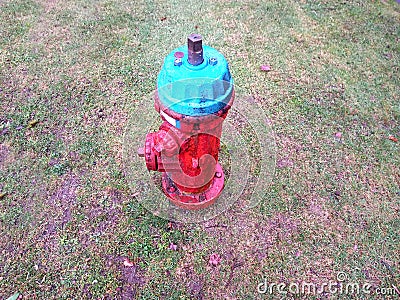 A red fire hydrant, faucet or fire hydrant, a water intake to provide a flow rate in the event of a fire. Water can be obtained fr Stock Photo