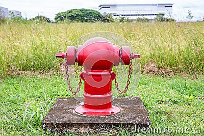 Red fire hydrants on the roadside in the community area are used to extinguish fires Stock Photo