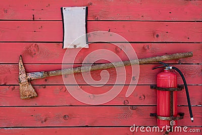 Red fire stand with axe and fire extinguisher Stock Photo