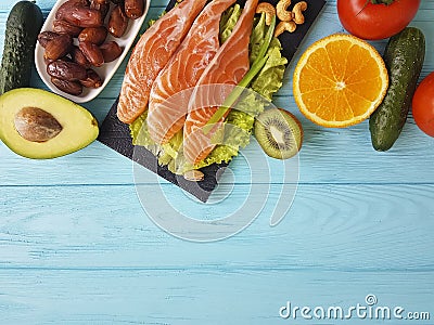 Red fish omega 3 , fresh avocado dinner nuts assortment on blue wooden, composition healthy food Stock Photo