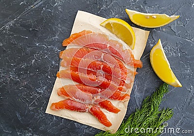 Red fish salted pieces, lemon seafood on concrete background Stock Photo