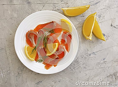 Red fish salted pieces, lemon on concrete background Stock Photo