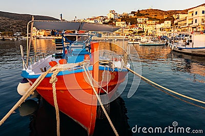 Red fishing boat in the harbor on Andros Stock Photo