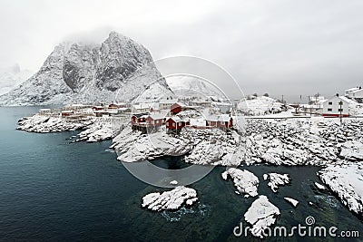Red fishing hut (rorbu) on the Hamnoy island in winter, Reine, L Stock Photo