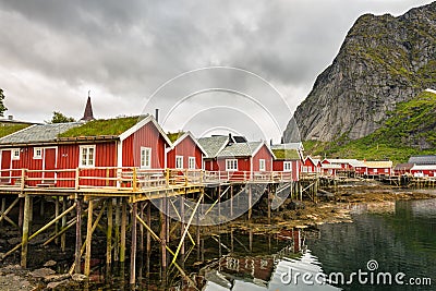 Red fishing huts called Rorbu in Reine, Norway Stock Photo