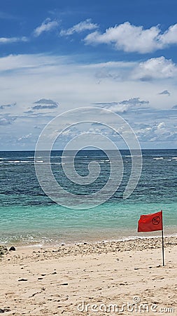 A red flag on a beach sign forbiden to swim Stock Photo