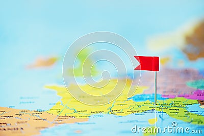 Red flag, pushpin, thumbtack pinned on map of europe. Copy space, travel concept Stock Photo