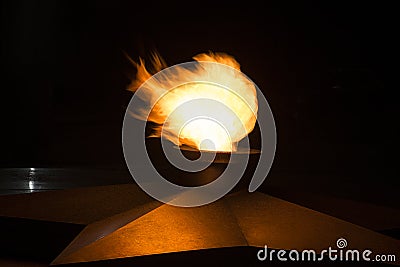 The red flames on a black background. Memorial of the Unknown Soldier in the Caucasus Stock Photo