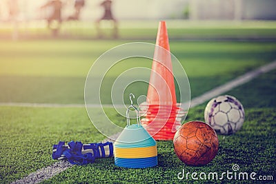 Red football and soccer training equipment on artificial turf. Stock Photo