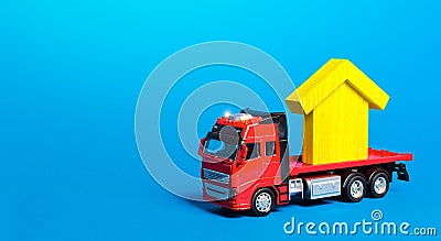 Red freight truck carrier with a yellow house figure. Home moving company. Transportation service and delivery of complex and Stock Photo