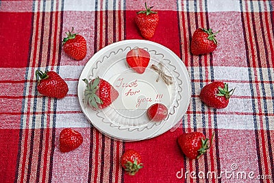 Red Fresh Strawberries on the Ceramic White Plate on the Check Tablecloth.Breakfast Organic Healthy Tasty Food.Wish Card.Cooking Stock Photo