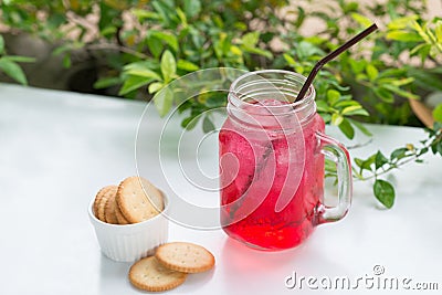 Red fruit flavor soft drink with biscuits. Stock Photo