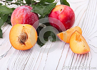 Red fruit plum with green leaves Stock Photo