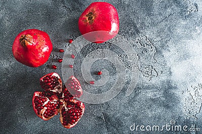 Red garnet fruits on dark background. Food background. Flat lay, top view Stock Photo