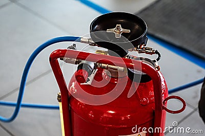red gas bottle with pressure gauge and tube Stock Photo