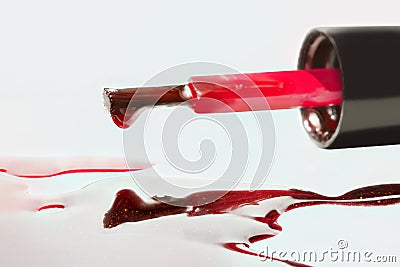 Red gel nail polish brush with splatters isolated on white background Stock Photo