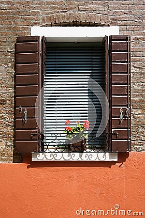 Red geraniums on window sill. Stock Photo
