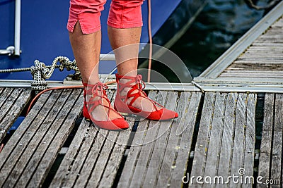 Red Ghillies with womans feet on a mooring at lake constance Stock Photo