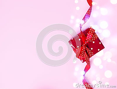 Red gift box on pink background. Presents for Christmas, valentine day, birthday, mother`s day. Stock Photo