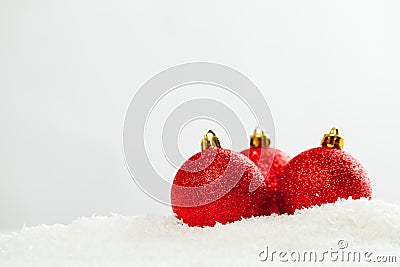 Red glass balls on white snow background. Christmas composition Stock Photo