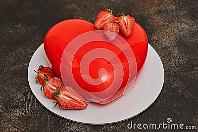 Red glaze mousse cake, heart shape form on dark background Stock Photo