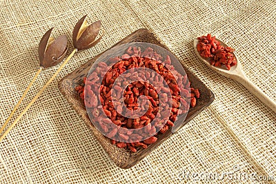 Red goji beans in a wooden cup - country style Stock Photo